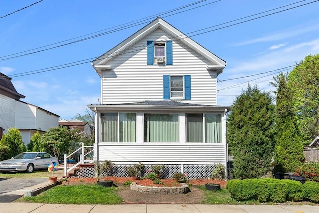 american foursquare style home featuring a sunroom