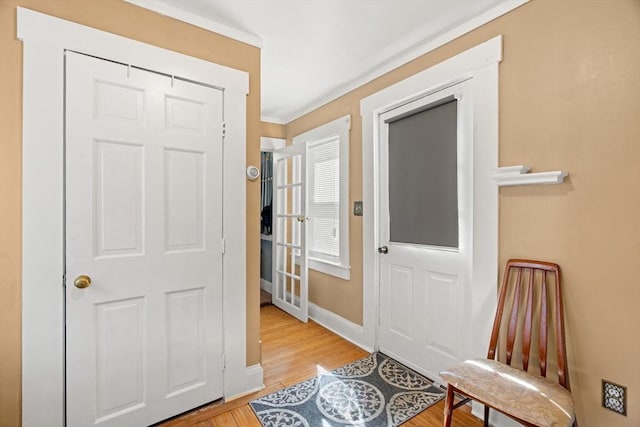 entrance foyer with baseboards and light wood finished floors