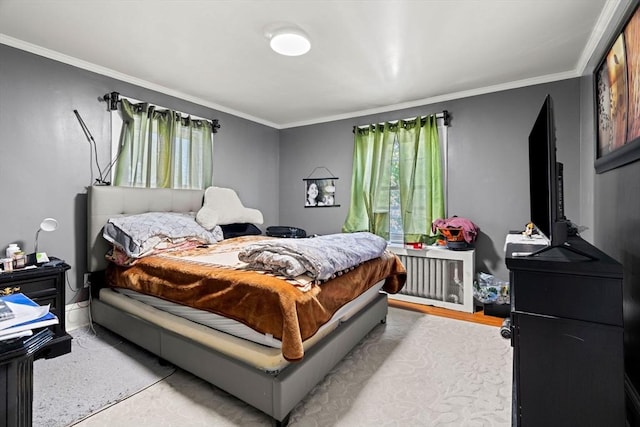 bedroom featuring ornamental molding, radiator, and baseboards