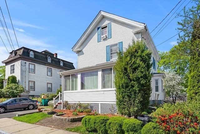 view of home's exterior with a sunroom