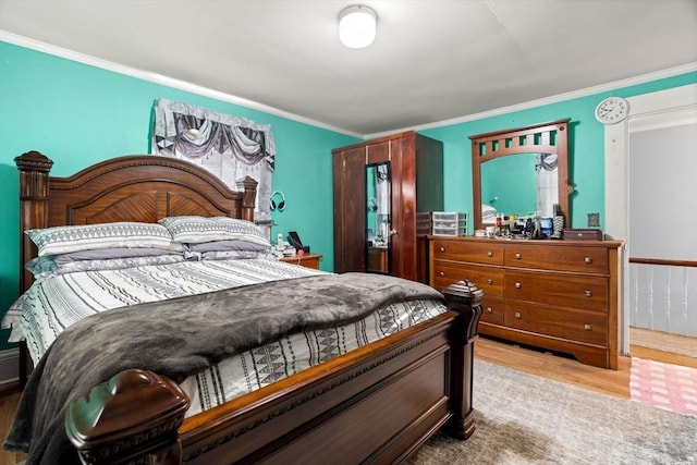 bedroom featuring wood finished floors and crown molding