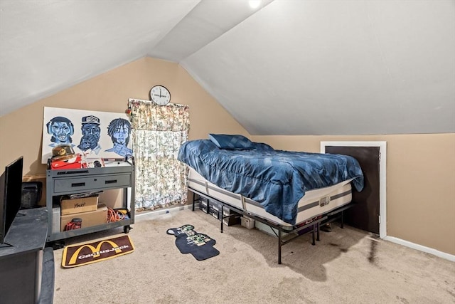 carpeted bedroom featuring lofted ceiling and baseboards