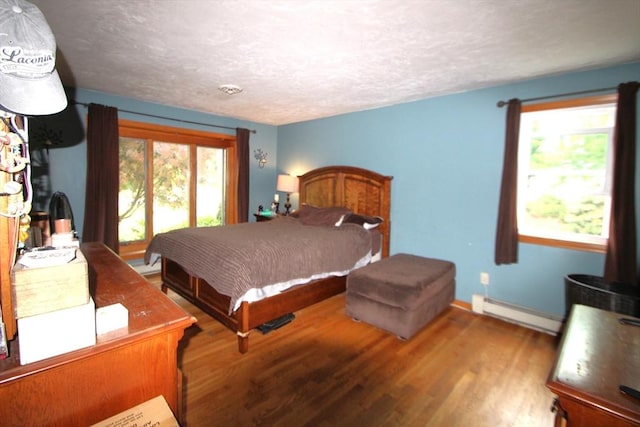 31 Trudeau Ln, East Bridgewater, MA 02333 - bedroom featuring a baseboard heating unit, wood finished floors, and a textured ceiling