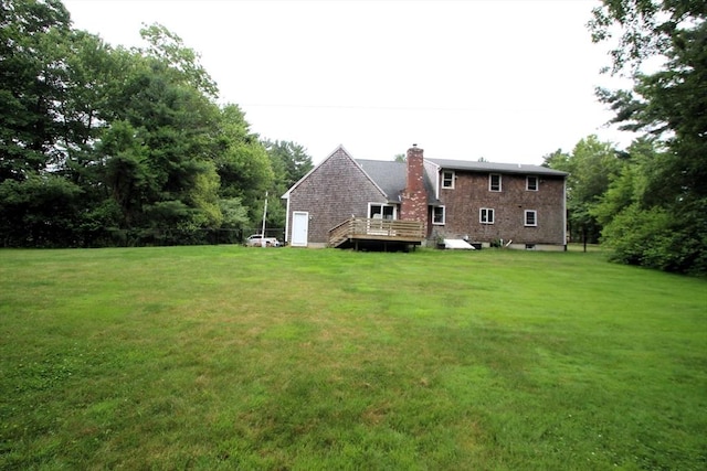 31 Trudeau Ln, East Bridgewater, MA 02333 - rear view of property featuring a lawn, a deck, and a chimney