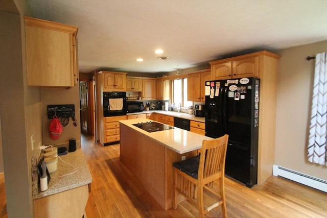 31 Trudeau Ln, East Bridgewater, MA 02333 - kitchen with black appliances, a baseboard heating unit, a kitchen island, light wood finished floors, and recessed lighting