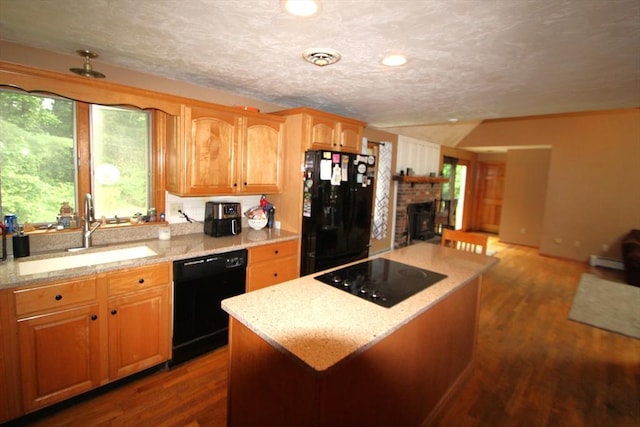 31 Trudeau Ln, East Bridgewater, MA 02333 - kitchen featuring black appliances, dark wood finished floors, open floor plan, a kitchen island, and light stone counters