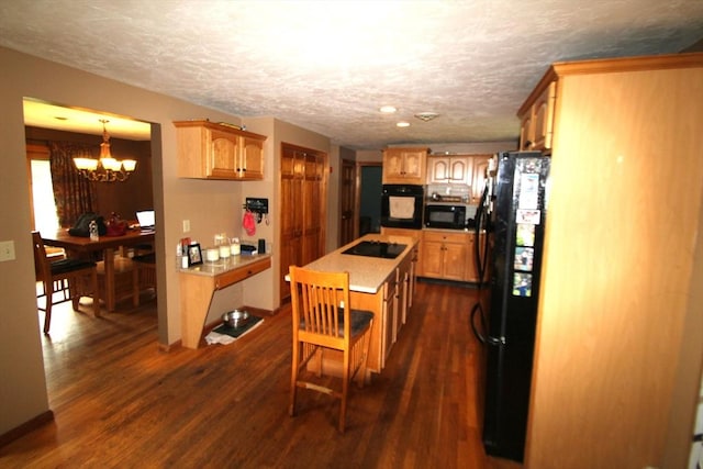 31 Trudeau Ln, East Bridgewater, MA 02333 - kitchen with black appliances, a kitchen island, a chandelier, a textured ceiling, and dark wood-style floors