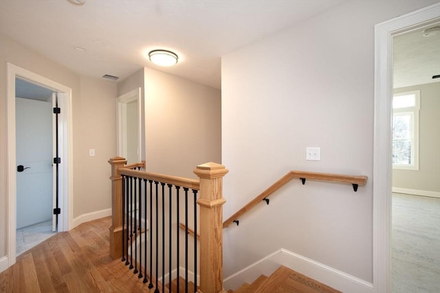 stairs featuring hardwood / wood-style floors