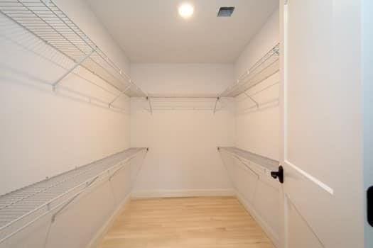 walk in closet featuring light hardwood / wood-style floors