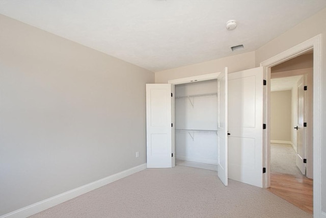 unfurnished bedroom featuring a closet and carpet