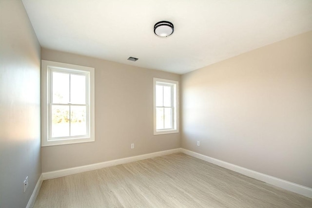 unfurnished room with light hardwood / wood-style flooring and a healthy amount of sunlight