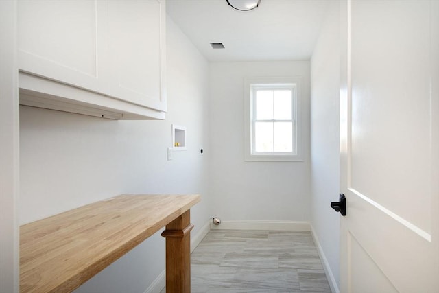 laundry area featuring cabinets, washer hookup, and electric dryer hookup