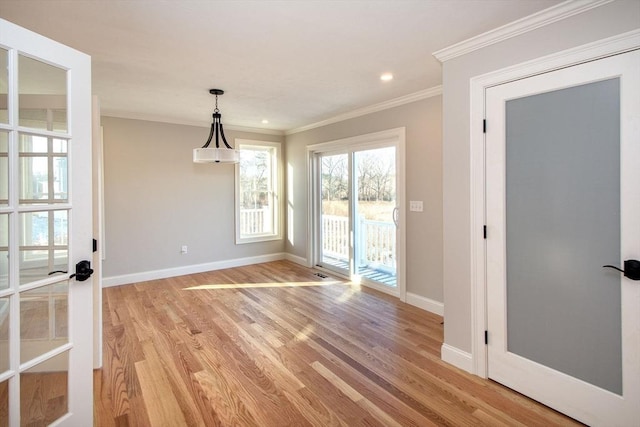 unfurnished dining area with crown molding and light hardwood / wood-style flooring