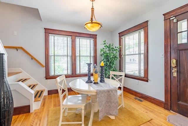 204 Massasoit Rd, Worcester, MA 01604 - dining room featuring stairs, healthy amount of natural light, light wood-style floors, and baseboards