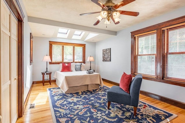 204 Massasoit Rd, Worcester, MA 01604 - bedroom featuring a skylight, multiple windows, baseboards, and light wood-type flooring