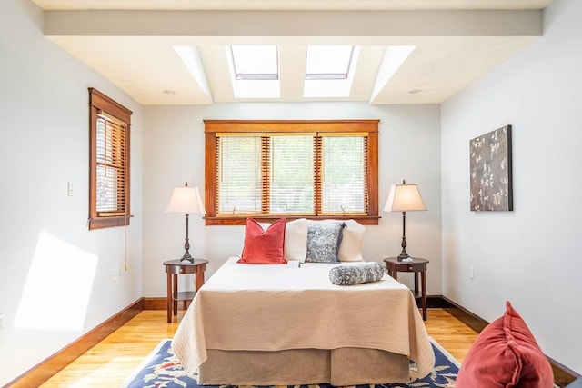 204 Massasoit Rd, Worcester, MA 01604 - bedroom with multiple windows, light wood-type flooring, a skylight, and baseboards
