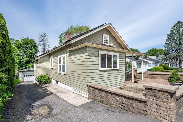 204 Massasoit Rd, Worcester, MA 01604 - view of property exterior featuring a chimney, a garage, and an outdoor structure
