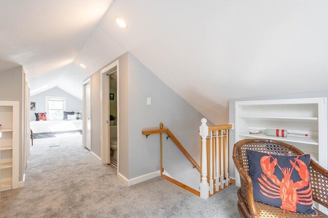 204 Massasoit Rd, Worcester, MA 01604 - hall with an upstairs landing, vaulted ceiling, carpet flooring, built in shelves, and baseboards