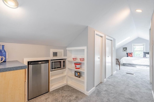204 Massasoit Rd, Worcester, MA 01604 - kitchen with lofted ceiling, stainless steel microwave, fridge, light colored carpet, and dark countertops