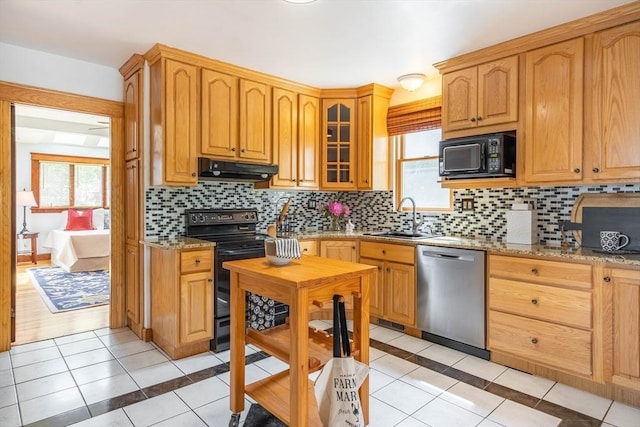 204 Massasoit Rd, Worcester, MA 01604 - kitchen with black appliances, light tile patterned flooring, under cabinet range hood, a sink, and plenty of natural light