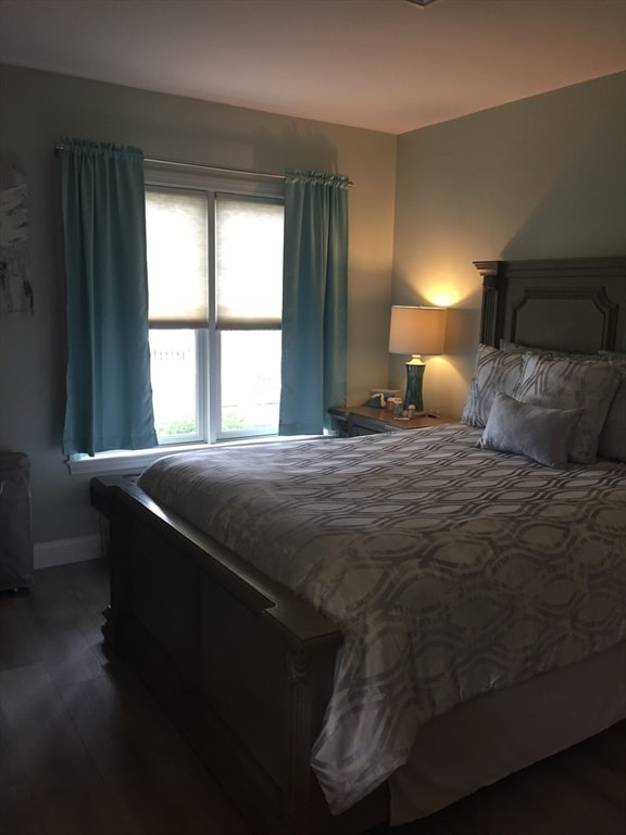 bedroom with dark wood-type flooring