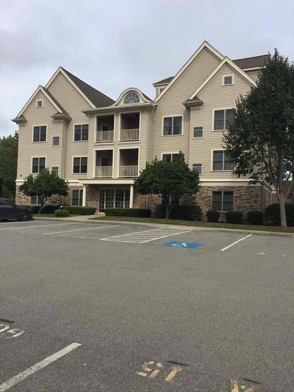 view of building exterior featuring uncovered parking