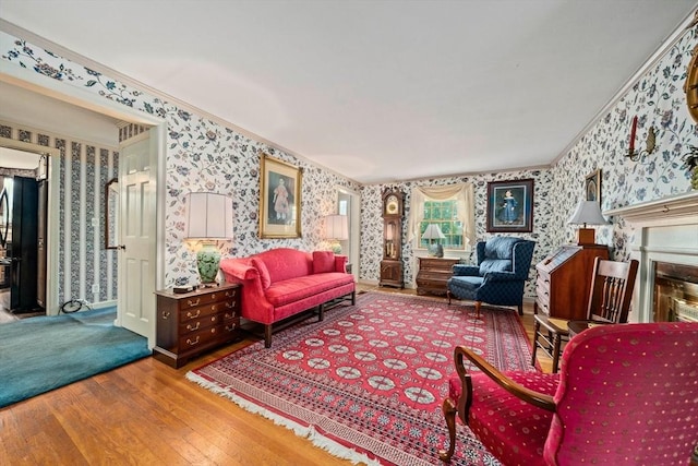 205 River St, Braintree, MA 02184 - living area featuring wallpapered walls, wood finished floors, ornamental molding, and a fireplace