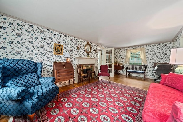 205 River St, Braintree, MA 02184 - living area with wallpapered walls, wood finished floors, ornamental molding, and a fireplace