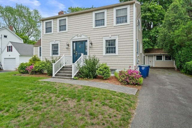 205 River St, Braintree, MA 02184 - colonial-style house featuring an outbuilding, a front yard, a chimney, and a garage