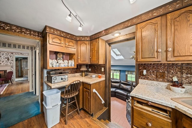 205 River St, Braintree, MA 02184 - kitchen with wood finished floors, decorative backsplash, and light stone countertops
