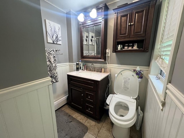104 Temple St, Gardner, MA 01440 - bathroom with a wainscoted wall, vanity, toilet, tile patterned floors, and a baseboard radiator