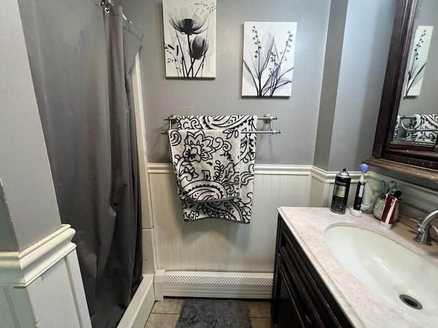 104 Temple St, Gardner, MA 01440 - bathroom with vanity, a wainscoted wall, a shower with shower curtain, a baseboard radiator, and tile patterned flooring