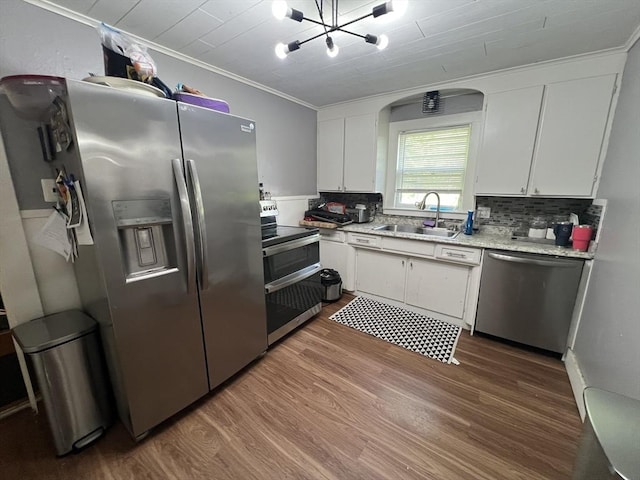 104 Temple St, Gardner, MA 01440 - kitchen featuring stainless steel appliances, a sink, wood finished floors, white cabinets, and crown molding