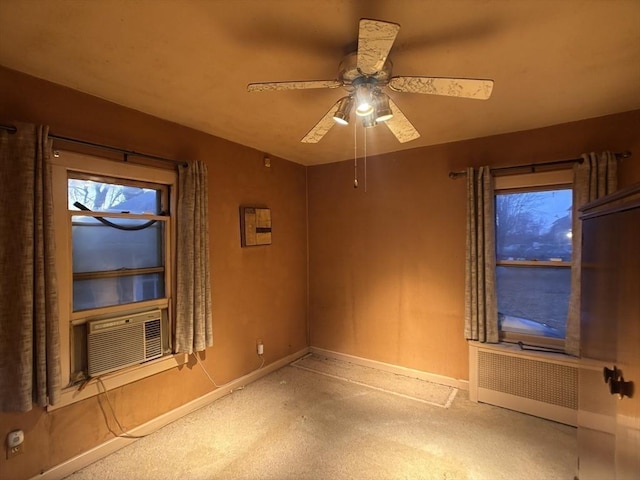 unfurnished room with ceiling fan, cooling unit, and radiator heating unit