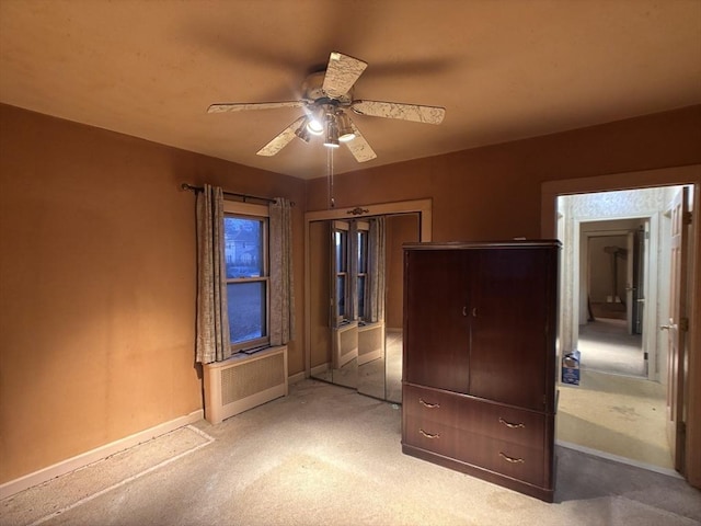 unfurnished bedroom featuring a closet, ceiling fan, and light carpet