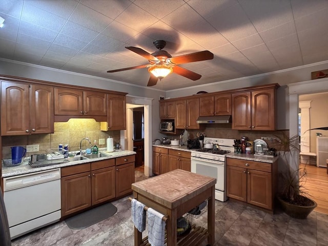 kitchen with white appliances, crown molding, ceiling fan, decorative backsplash, and sink