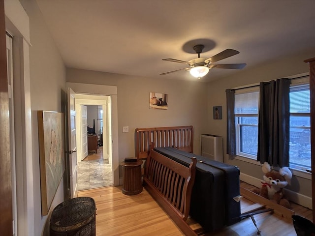 bedroom featuring ceiling fan and light hardwood / wood-style floors