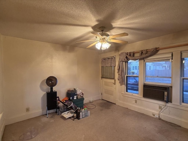 unfurnished living room with a textured ceiling, carpet floors, ceiling fan, and cooling unit