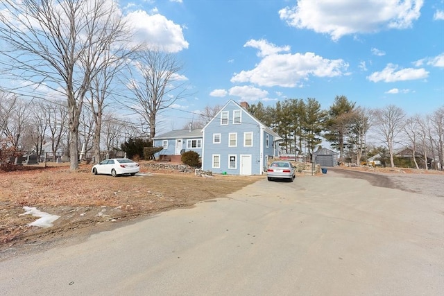 view of front of house featuring a chimney