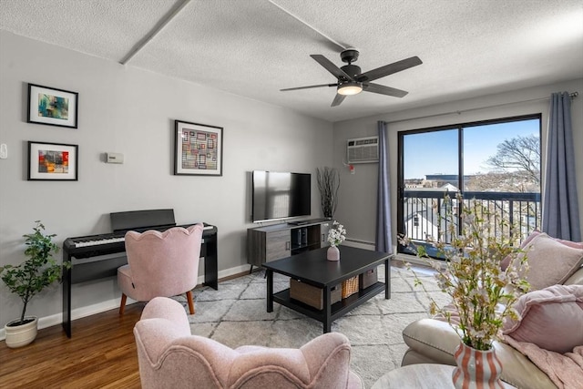 10 Williams St Unit 45, Watertown, MA 02472 - living area featuring baseboards, ceiling fan, a wall mounted AC, a textured ceiling, and wood finished floors