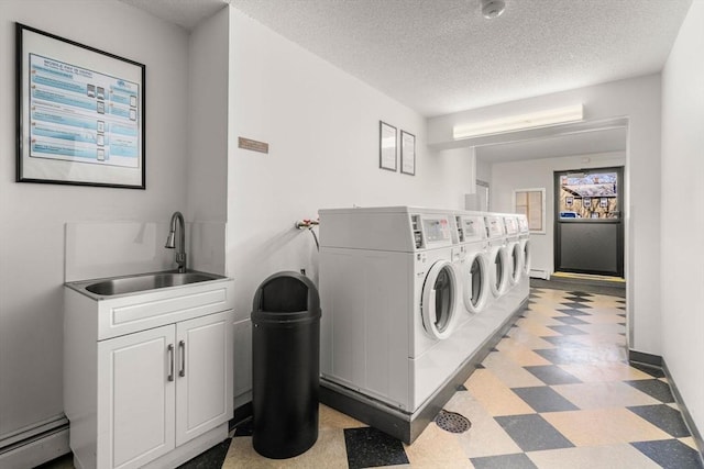 10 Williams St Unit 45, Watertown, MA 02472 - common laundry area with baseboard heating, a textured ceiling, washer and clothes dryer, light floors, and a sink
