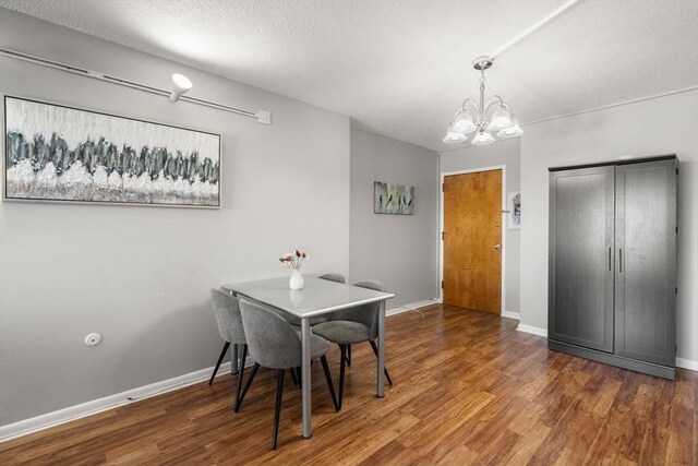 10 Williams St Unit 45, Watertown, MA 02472 - dining area with baseboards, a chandelier, wood finished floors, and a textured ceiling