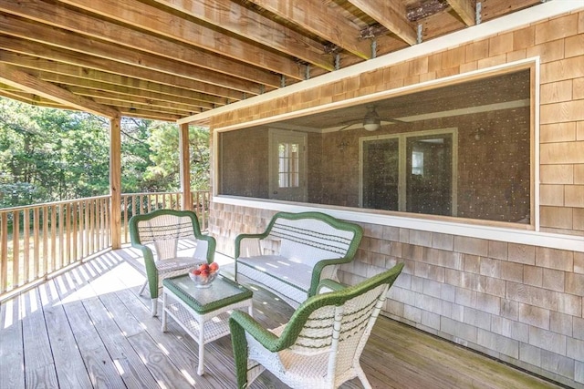 wooden deck featuring ceiling fan