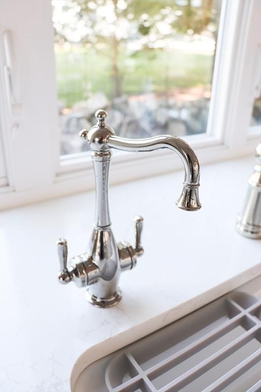 interior details with white cabinets and sink