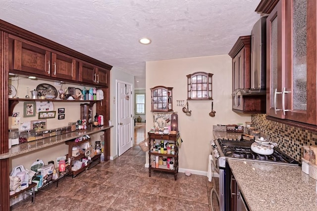 11 Azalea Ln Unit 11, Marlborough, MA 01752 - kitchen with stainless steel range with gas stovetop, backsplash, light stone countertops, open shelves, and a textured ceiling