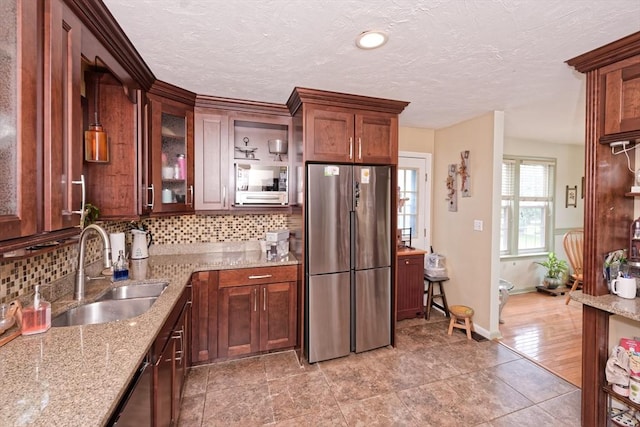 11 Azalea Ln Unit 11, Marlborough, MA 01752 - kitchen featuring freestanding refrigerator, tasteful backsplash, light stone countertops, glass insert cabinets, and a textured ceiling