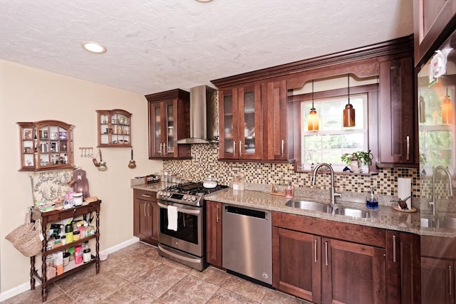 11 Azalea Ln Unit 11, Marlborough, MA 01752 - kitchen with appliances with stainless steel finishes, wall chimney exhaust hood, backsplash, light stone countertops, and glass insert cabinets
