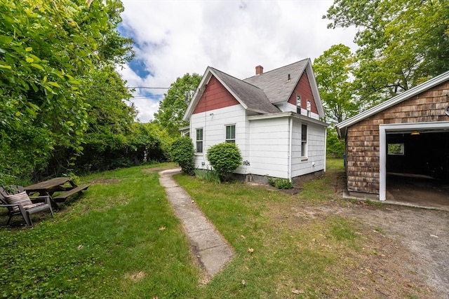 6 Oak St, Monson, MA 01057 - view of property exterior with a yard, a chimney, an outbuilding, and a garage