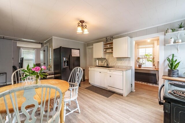 6 Oak St, Monson, MA 01057 - dining area featuring radiator, plenty of natural light, light wood-style flooring, and crown molding