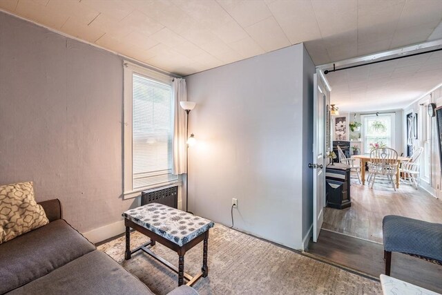 6 Oak St, Monson, MA 01057 - living room with wood finished floors, radiator, and baseboards